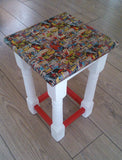 Marvel Stool. With a serious amount of sanding, a lick of paint and transferring a marvel collage onto it using the decoupage technique, it has been completely transformed and been given a new lease of life. Could also be used as a little side table 